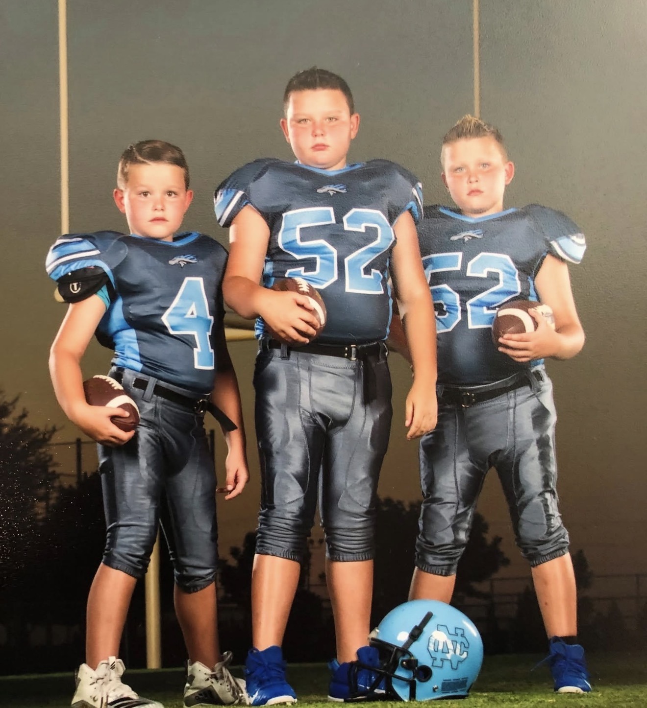 Brody and his two brothers as children, together in their football uniforms