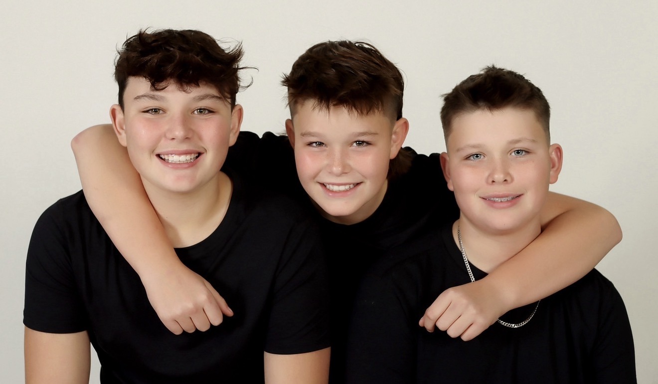 Brody and his two younger brothers smiling together when they were younger