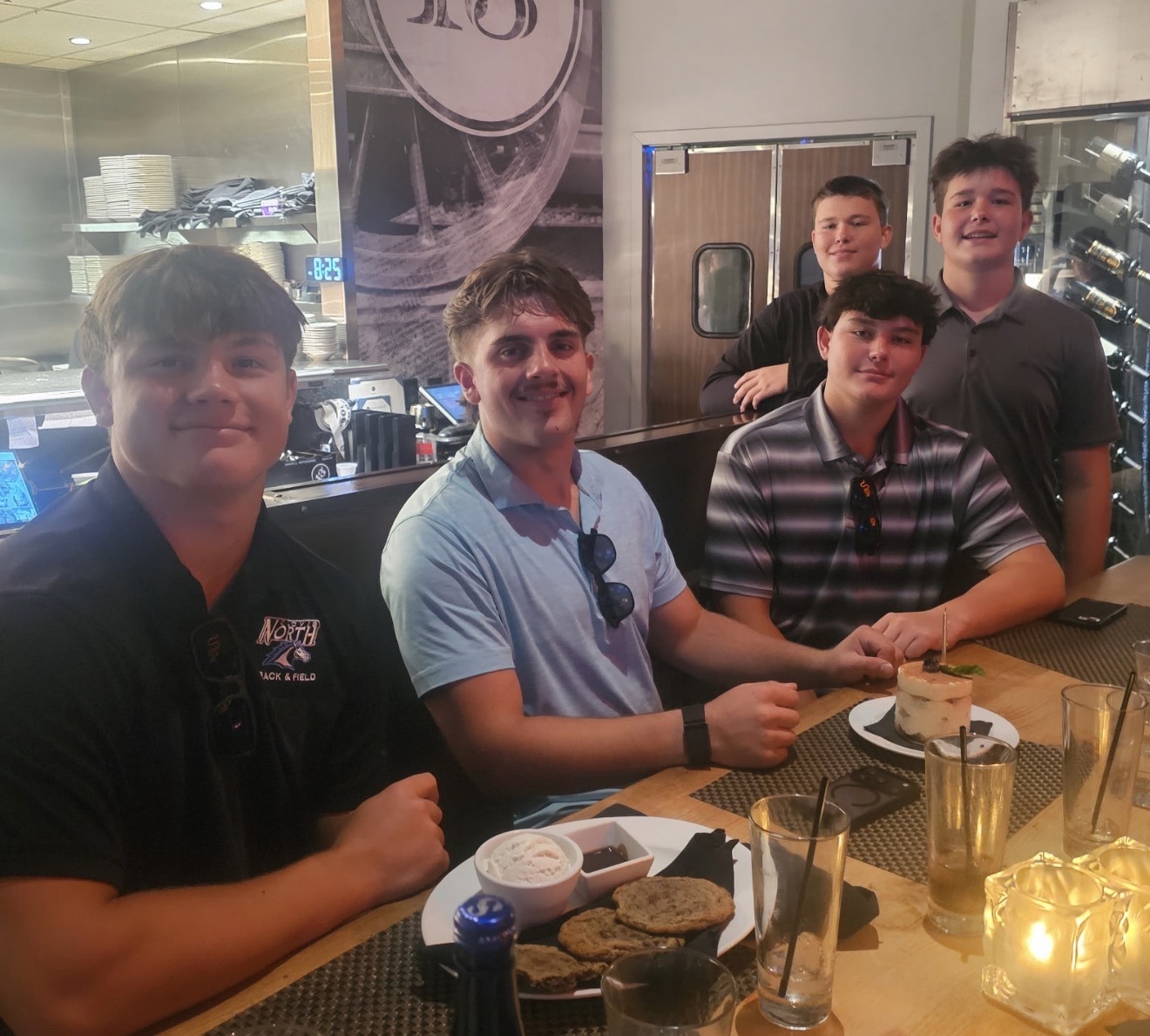 Brody and friends sharing a meal at a restaurant